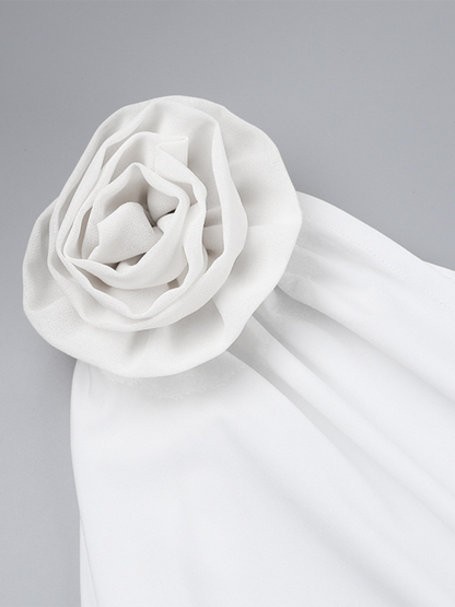 Close-up of the three-dimensional floral appliques on the white one-shoulder dress - Let Us Vogue